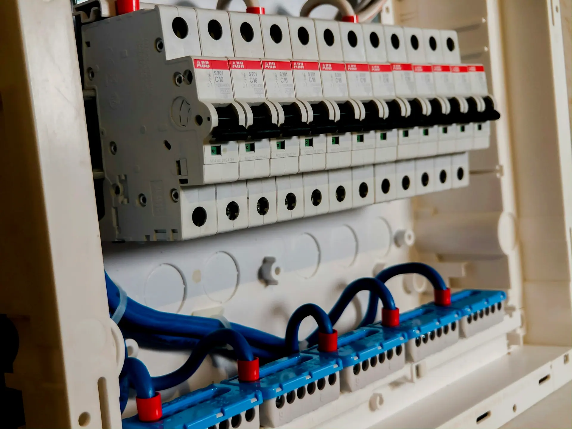 Quadro elétrico aberto, com disjuntores em régua e cabeamento identificado